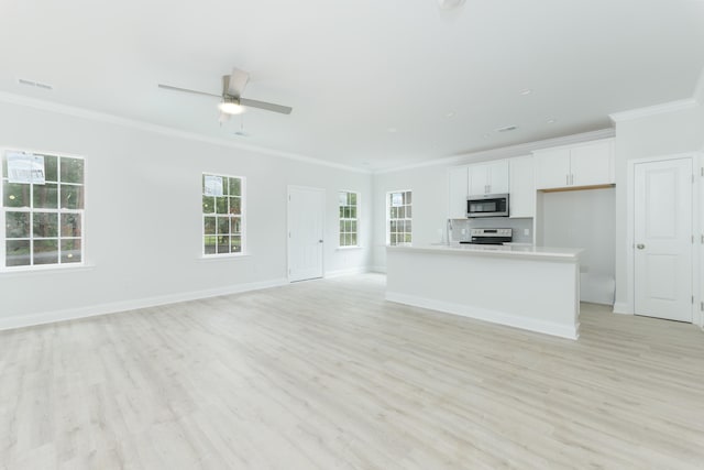 kitchen with a kitchen island with sink, range, light wood-type flooring, white cabinetry, and ceiling fan