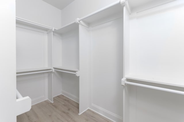 spacious closet featuring light hardwood / wood-style floors