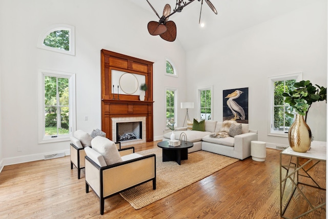 125 Drayton Dr, Summerville, SC 29483 - living area with high vaulted ceiling, plenty of natural light, light wood-type flooring, baseboards, and a fireplace