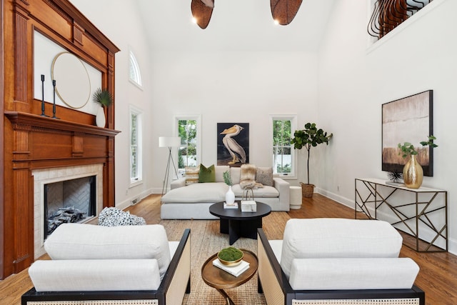 125 Drayton Dr, Summerville, SC 29483 - living area featuring high vaulted ceiling, a tile fireplace, plenty of natural light, baseboards, and wood finished floors