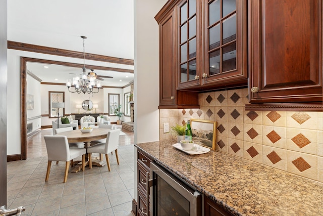 125 Drayton Dr, Summerville, SC 29483 - kitchen featuring wine cooler, a chandelier, crown molding, tasteful backsplash, and stone countertops