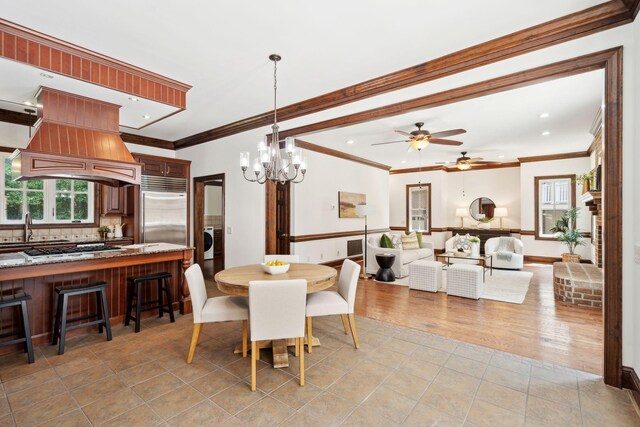 125 Drayton Dr, Summerville, SC 29483 - dining room with plenty of natural light, a ceiling fan, crown molding, light tile patterned floors, and a chandelier
