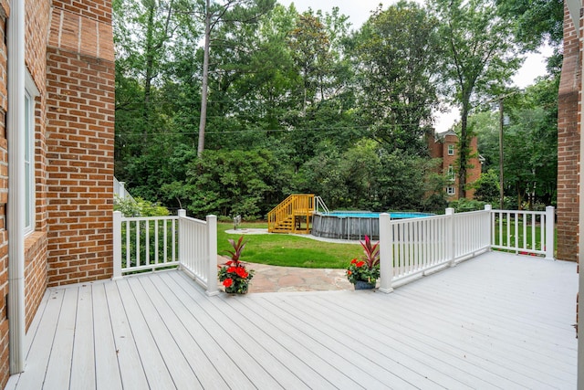 125 Drayton Dr, Summerville, SC 29483 - wooden deck featuring an outdoor pool, a lawn, and view of wooded area