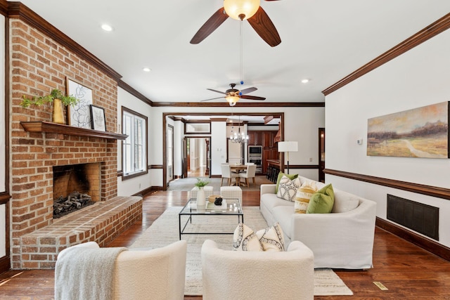 125 Drayton Dr, Summerville, SC 29483 - living room featuring crown molding, a ceiling fan, a fireplace, a chandelier, and baseboards