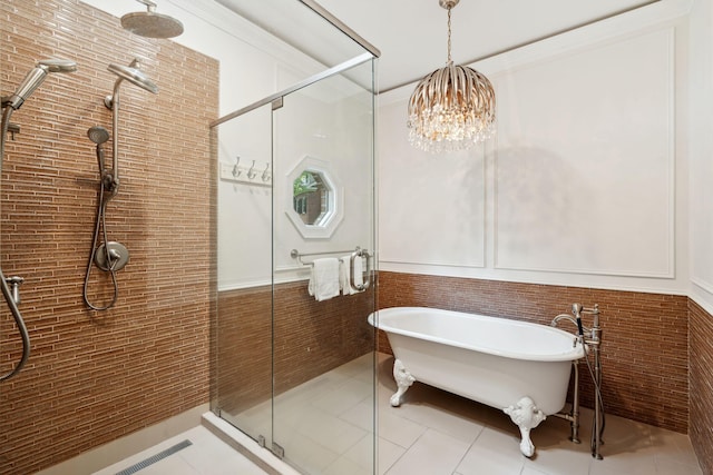 125 Drayton Dr, Summerville, SC 29483 - bathroom with a stall shower, a soaking tub, a wainscoted wall, tile patterned flooring, and a chandelier