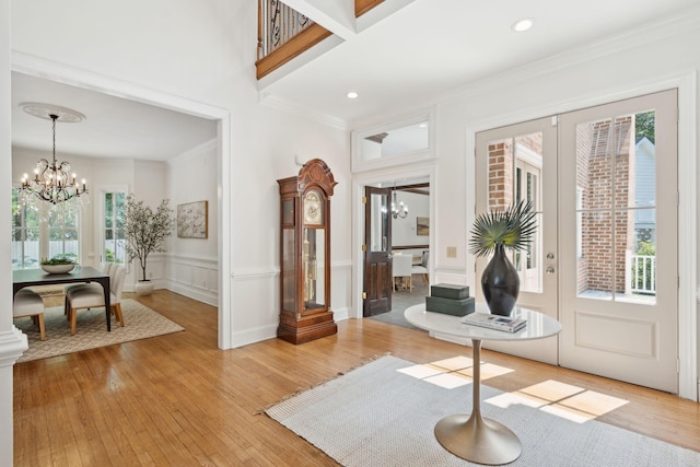 125 Drayton Dr, Summerville, SC 29483 - entrance foyer with a chandelier, crown molding, light wood finished floors, a wainscoted wall, and a decorative wall