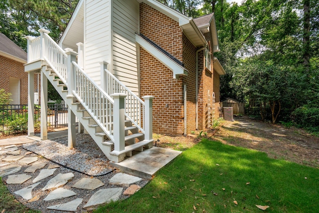 125 Drayton Dr, Summerville, SC 29483 - view of side of home featuring brick siding, stairway, and a yard