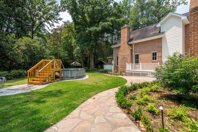 125 Drayton Dr, Summerville, SC 29483 - view of green lawn with an outdoor pool and a wooden deck