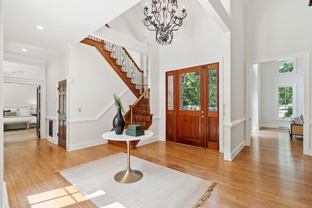 125 Drayton Dr, Summerville, SC 29483 - entrance foyer with stairway, light wood-style floors, a high ceiling, a chandelier, and baseboards