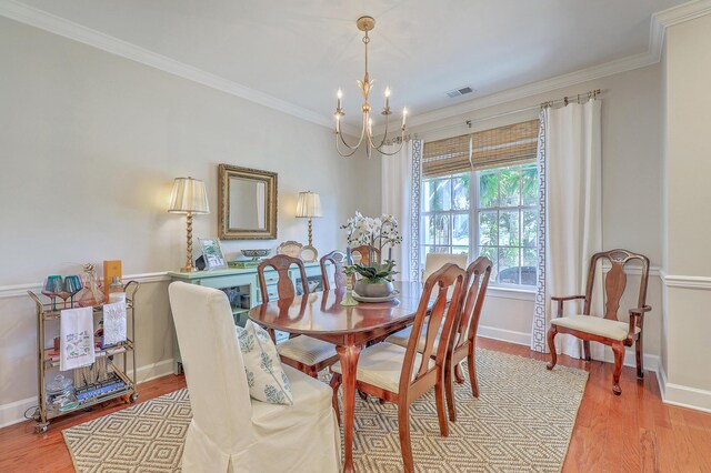 1723 Brittlebush Ln, Johns Island, SC 29455 - dining space with a chandelier, light wood-style flooring, and crown molding