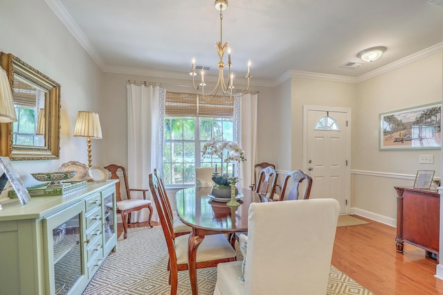 1723 Brittlebush Ln, Johns Island, SC 29455 - dining space featuring beverage cooler, light wood finished floors, crown molding, and a chandelier