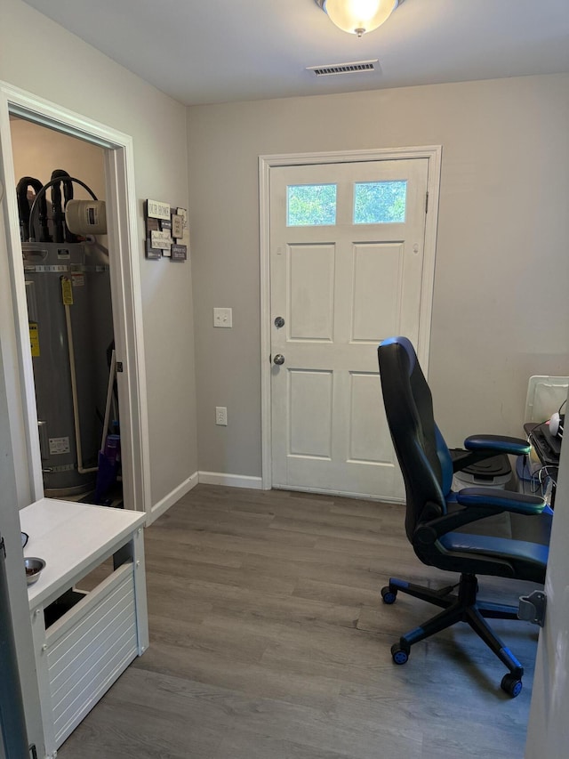 304 Carolina Cir, Walterboro, SC 29488 - home office with wood finished floors, strapped water heater, and baseboards