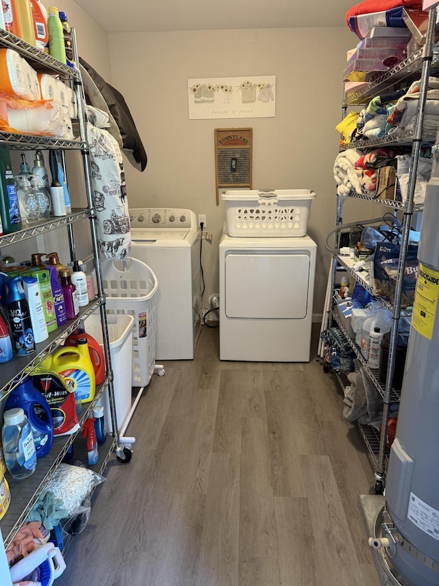 304 Carolina Cir, Walterboro, SC 29488 - laundry area featuring washer and dryer, wood finished floors, and gas water heater