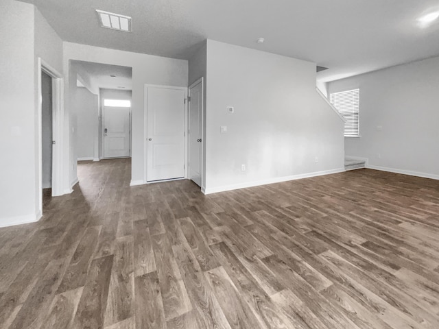 unfurnished room featuring dark wood-type flooring