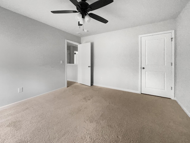 empty room with carpet and ceiling fan