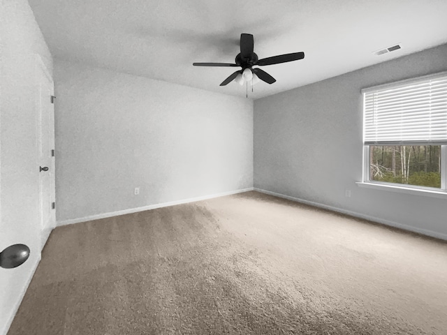 unfurnished room with ceiling fan and carpet flooring