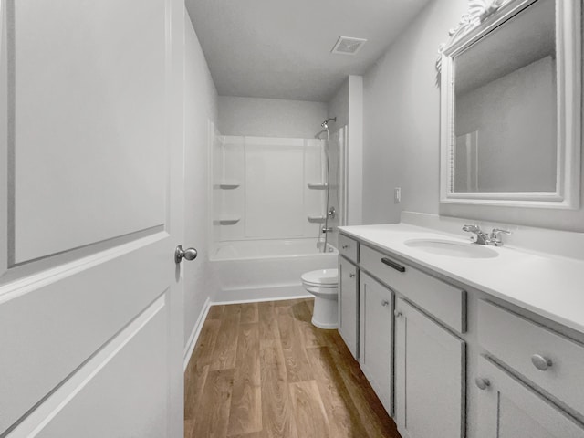 full bathroom featuring toilet, vanity, bathtub / shower combination, and hardwood / wood-style floors