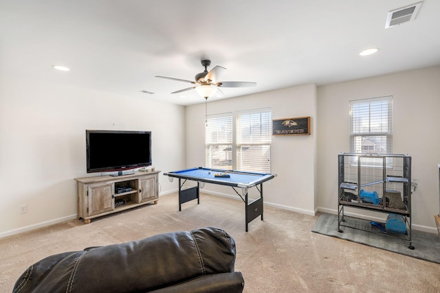 rec room with visible vents, plenty of natural light, light colored carpet, and baseboards