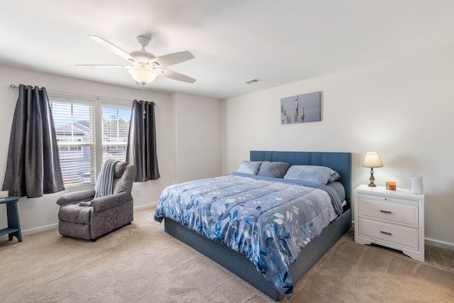 carpeted bedroom with a ceiling fan, baseboards, and visible vents