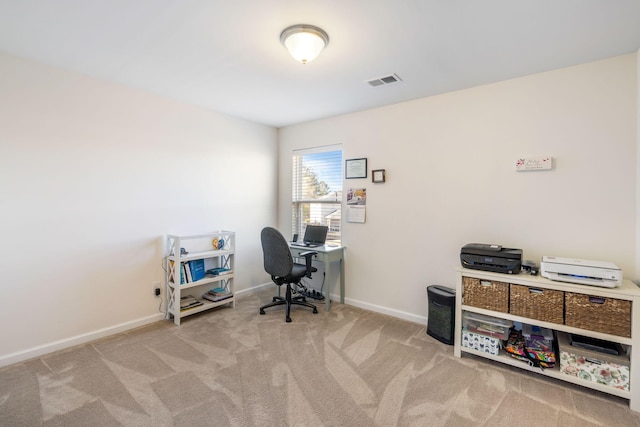 home office with visible vents, light carpet, and baseboards