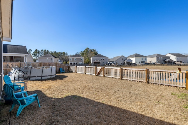 view of yard featuring a fenced in pool, a residential view, and a fenced backyard