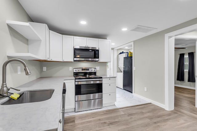 1979 Macon Ave, North Charleston, SC 29405 - kitchen featuring stainless steel appliances, a sink, open shelves, white cabinets, and recessed lighting