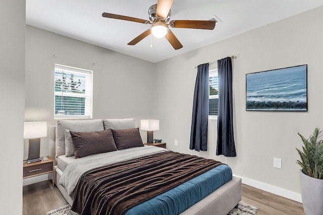 1979 Macon Ave, North Charleston, SC 29405 - bedroom featuring multiple windows, wood finished floors, baseboards, and a ceiling fan