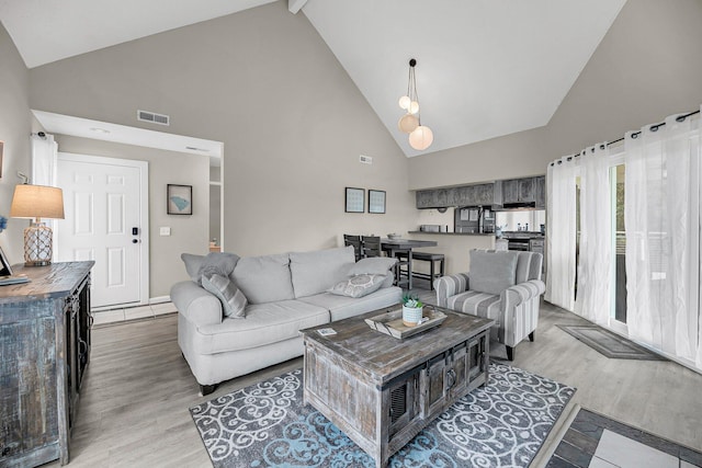 202 Mariners Cay Dr, Folly Beach, SC 29439 - living area with high vaulted ceiling, wood finished floors, and beamed ceiling