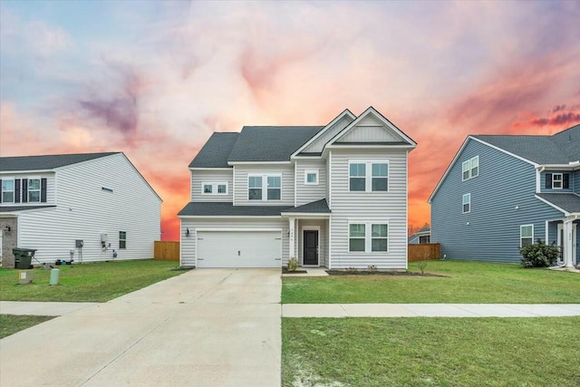 view of front of house featuring a yard and a garage