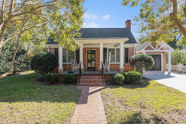 view of front of house with a porch, a garage, and a front lawn