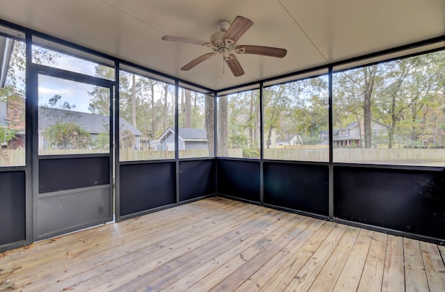 unfurnished sunroom featuring ceiling fan