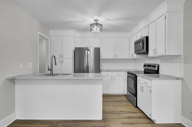 kitchen featuring appliances with stainless steel finishes, white cabinets, sink, and light hardwood / wood-style floors