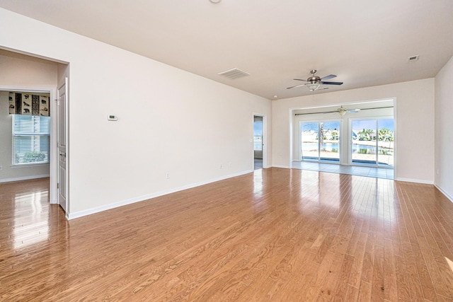 empty room featuring ceiling fan and light wood-type flooring