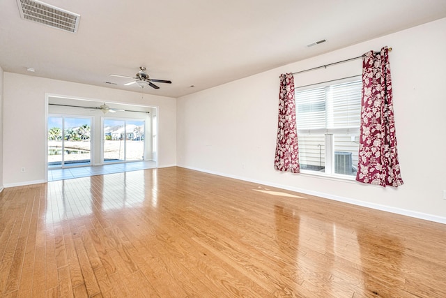 spare room featuring light hardwood / wood-style floors, plenty of natural light, and ceiling fan