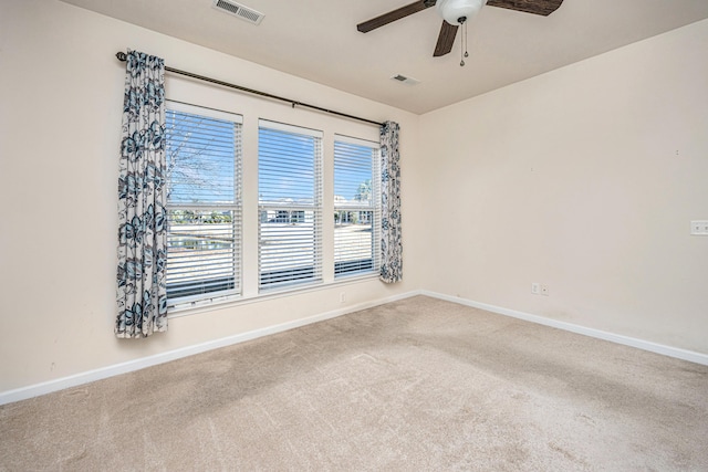 spare room featuring ceiling fan and carpet flooring