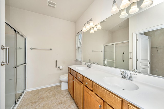 bathroom with walk in shower, vanity, tile patterned floors, and toilet