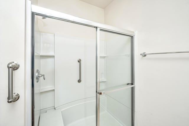 bathroom with a shower with shower door