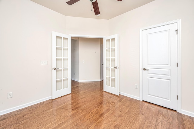 unfurnished bedroom featuring light wood-type flooring, ceiling fan, and french doors