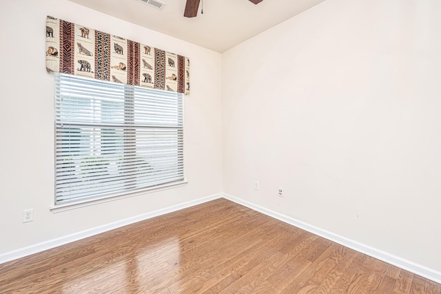 empty room with ceiling fan and hardwood / wood-style flooring