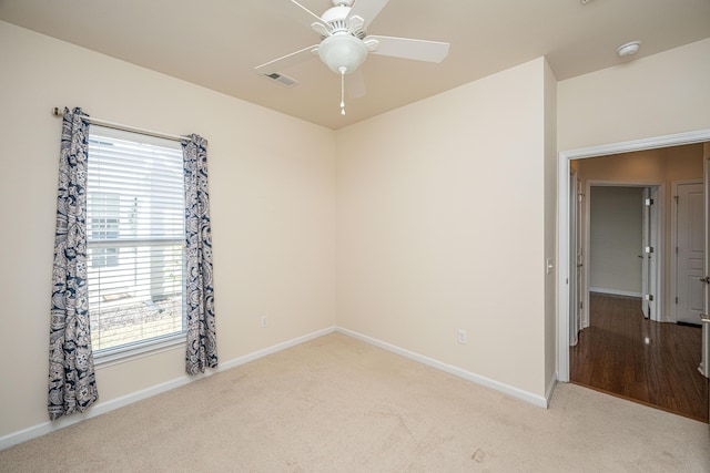 unfurnished room featuring ceiling fan and light colored carpet