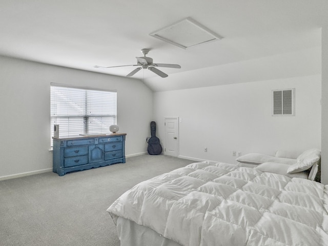 bedroom featuring carpet, attic access, visible vents, and vaulted ceiling