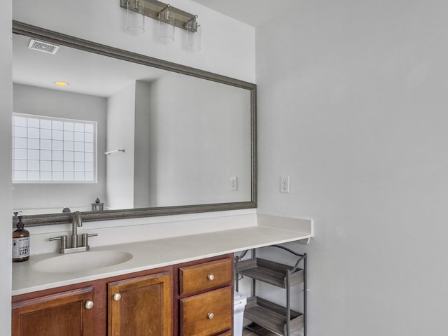 bathroom with vanity and visible vents