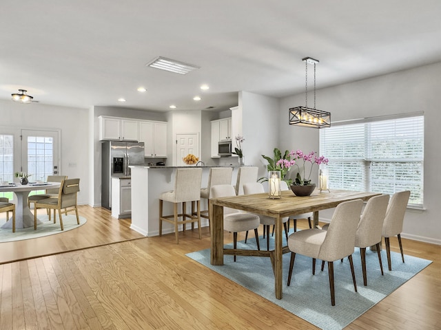 dining area with recessed lighting, baseboards, visible vents, and light wood finished floors