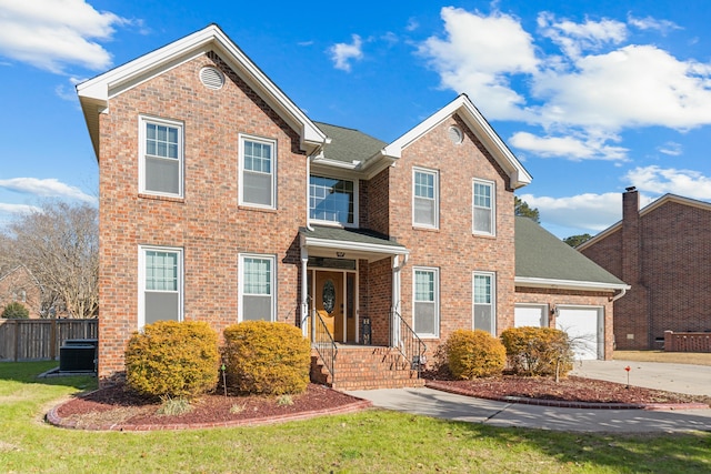 traditional-style home with brick siding, concrete driveway, an attached garage, fence, and a front lawn