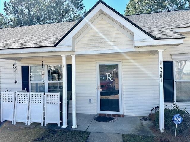 view of exterior entry featuring a porch