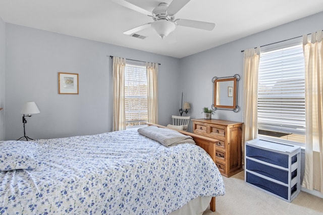 bedroom featuring light carpet and ceiling fan