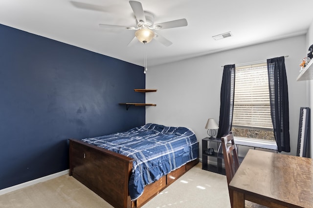 bedroom featuring multiple windows, light colored carpet, and ceiling fan