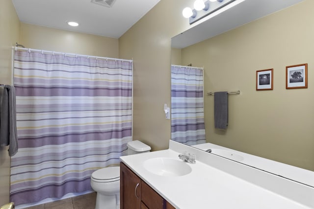 bathroom with tile patterned flooring, vanity, and toilet