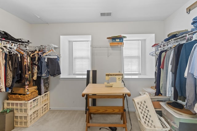 spacious closet featuring light carpet