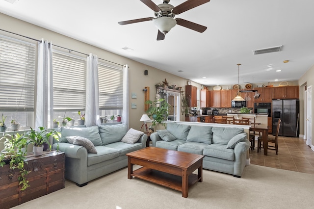 living room with light tile patterned flooring and ceiling fan